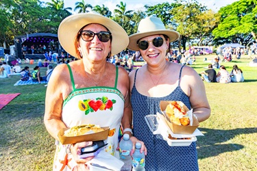 Two Ladies holding their hotdogs