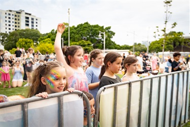 Children standing behind a barrier