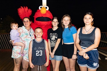 Family standing with Elmo