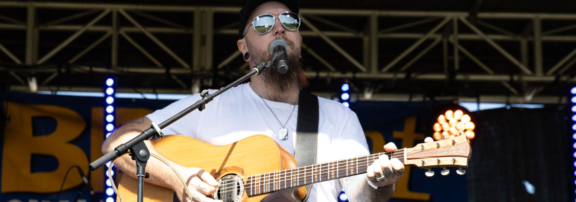 Male playing guitar on stage